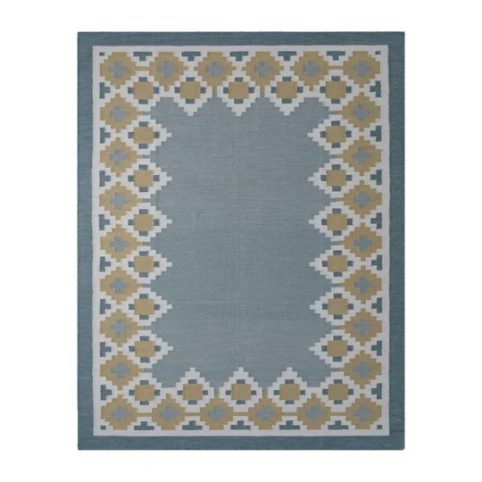Nordis handwoven flatweave wool rug featuring a Scandinavian geometric border in blue, mustard, beige, and ivory, handmade for modern living rooms, bedrooms, and Nordic interiors.