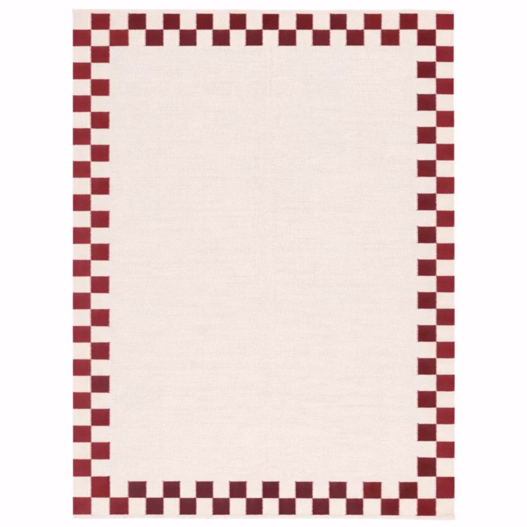 Verra handwoven cotton area rug featuring a cream base with a red checker border in a flatweave design for Scandinavian, farmhouse, and modern interiors.